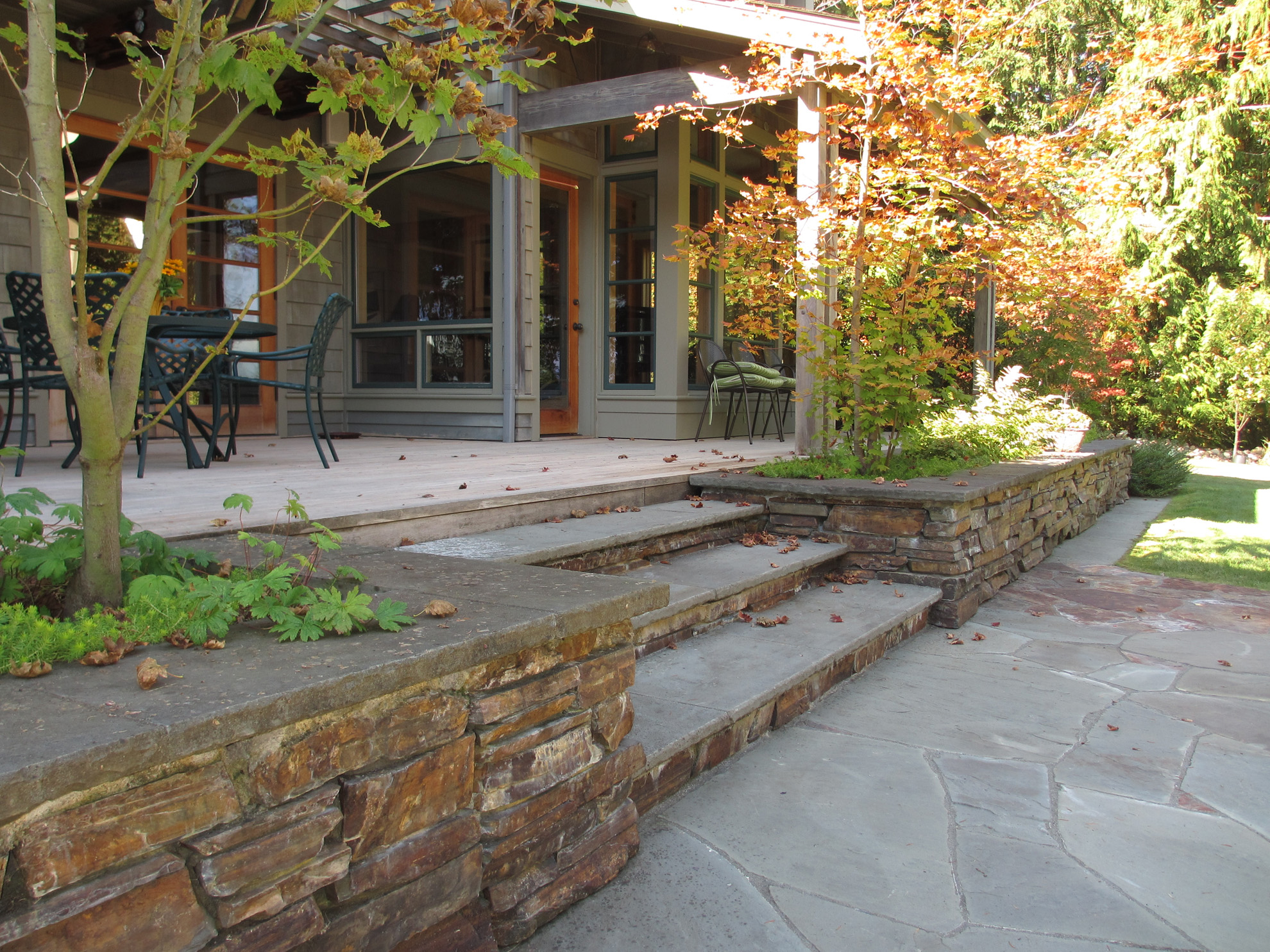 deck with stone planter and steps